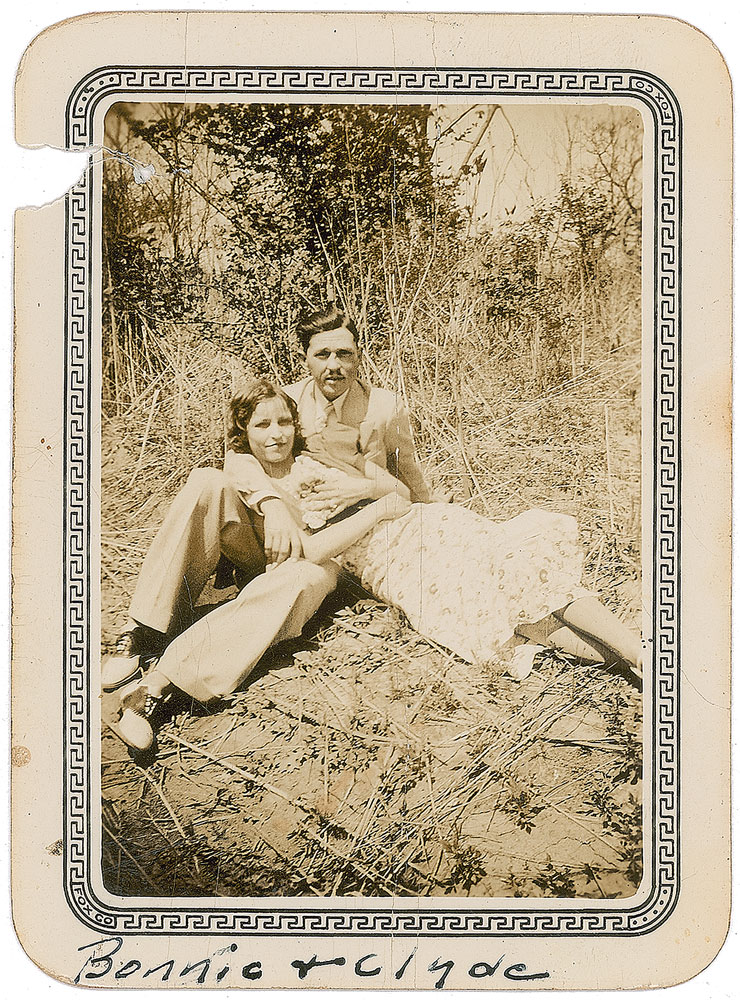 Rare original sepia candid shot of Bonnie and Clyde. The bottom text reads "Bonnie + Clyde" written in fountain pen by an unknown hand. This photo was sold as part of a set for $3,063 in July 2016. 
