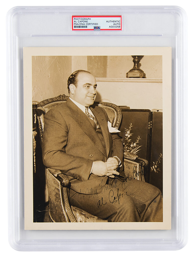 Dastardly dapper Capone in a rare vintage signed photograph. Inscribed in fountain pen the text reads, "To My Friend Joe Cook, Al Capone." This photograph was one of the largest ever offered at auction.