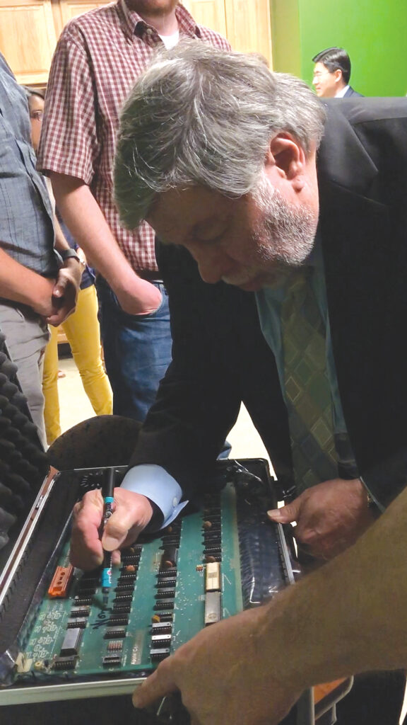 Apple co-founder Steve Wozniak signing the Apple-1 motherboard board.