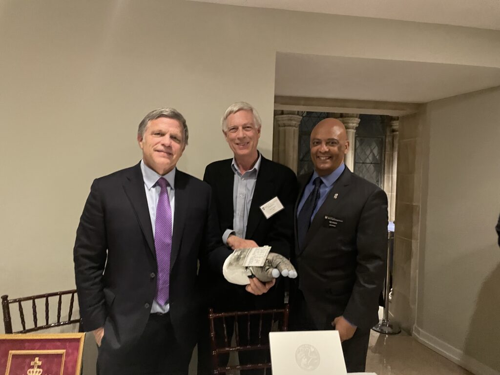 Author Douglas Brinkley (left) trying on the lunar cuff with consignor Roger Wagner (middle) and Ted Adams (right).
