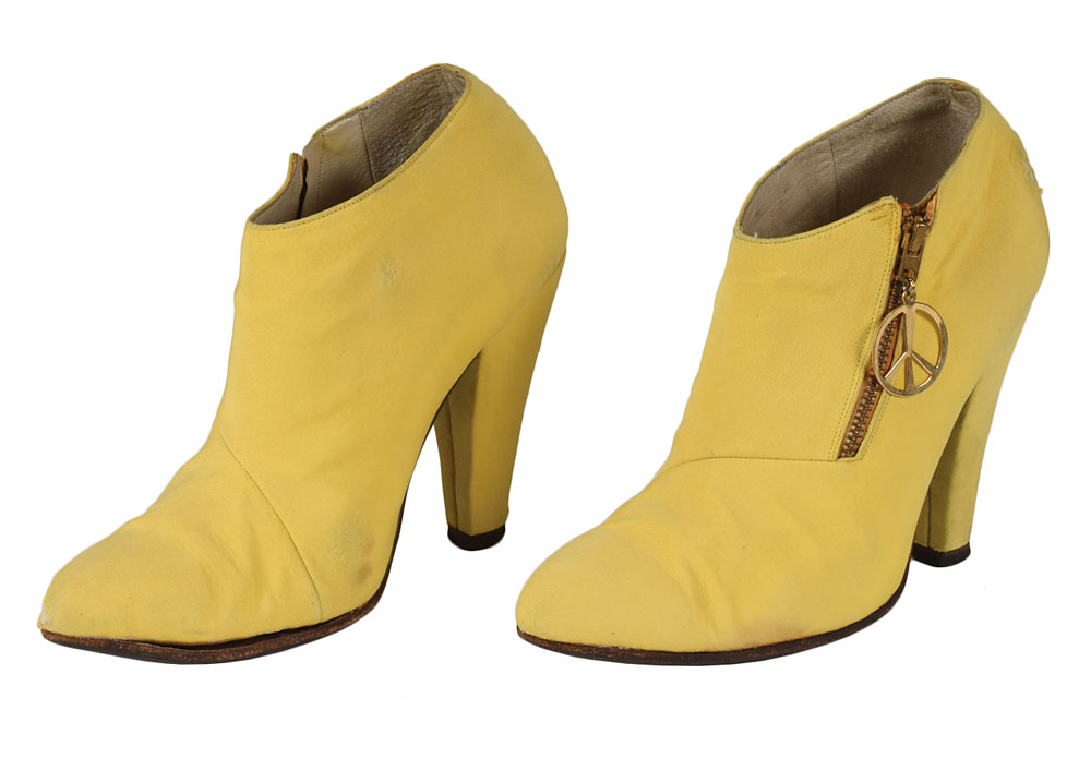 Prince's stage-worn yellow satin boots complete with a peace sign zipper. The extravagant singer wore these boots for several years between 1986 and 1992, including during his Sign o' the Times tour in 1987.