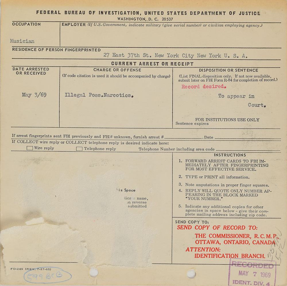 The reverse of the arrest card showcases the reason for Hendrix's detainment as 'Illegal poss. Narcotics.'