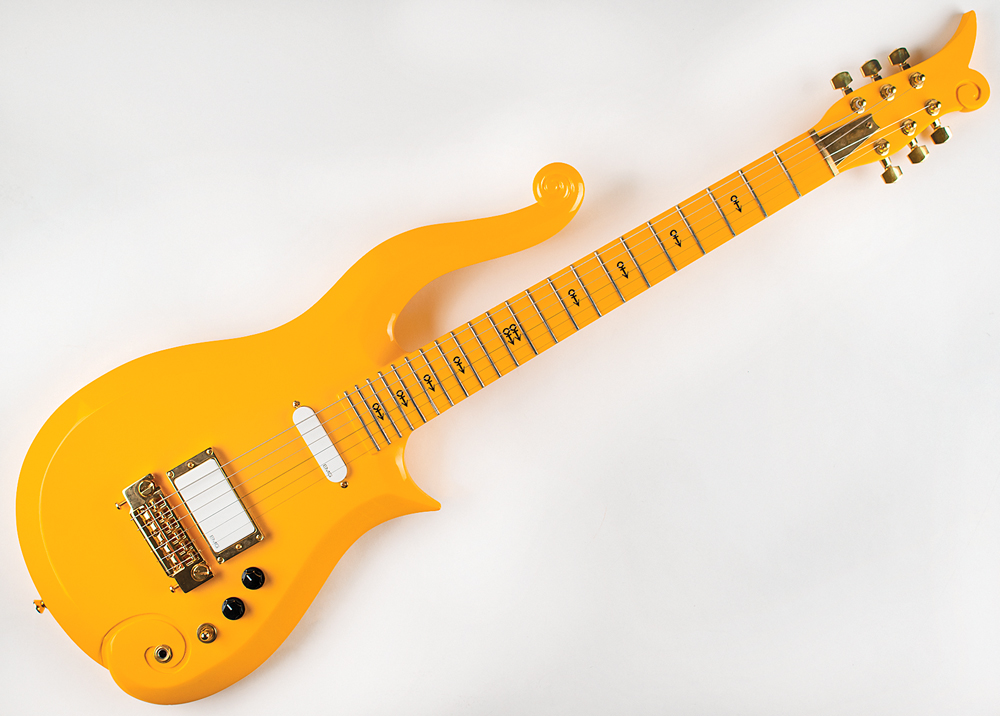 Prince's bright yellow custom-made cloud guitar featuring a cloud inspired design and 18 black Prince symbols going from the fretboard to the top of the neck.