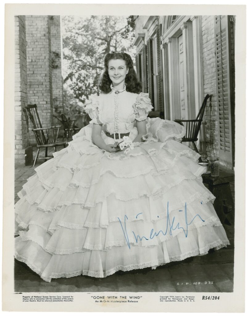 A signed full portrait of Vivien Leigh in costume as Scarlett O'Hara for 1939 film, Gone With the Wind. This elegant photo sold for $6,488.