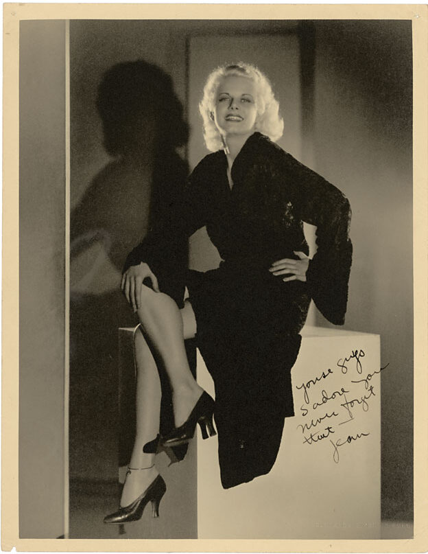 Oversized portrait of Harlow posing in a black dress atop a white cube inscribed to two of her close friends.