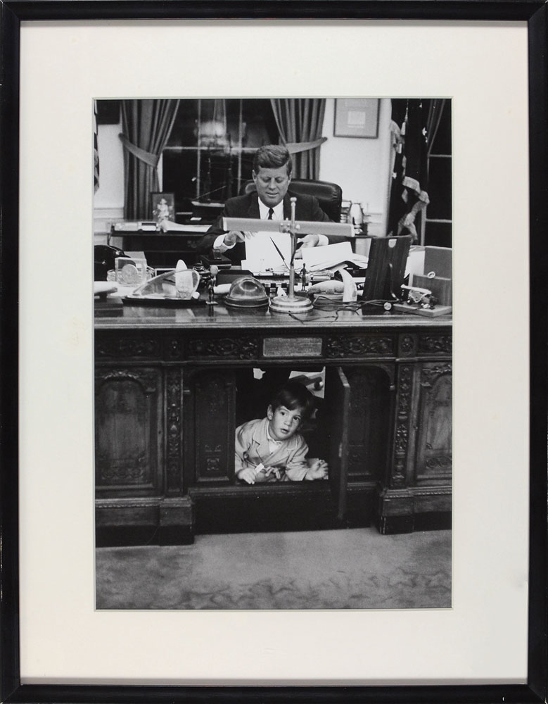 Official photograph of John F. Kennedy and John, Jr. in the oval office that hung in the White House but was later removed on November 22, 1963. RR Auction sold this familial photo for $29,400.