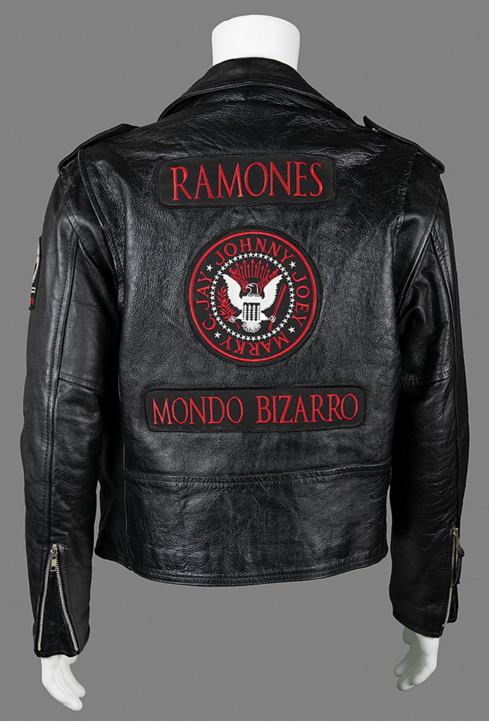 The reverse features the band’s name, logo, and the words Mondo Bizarro embroidered.