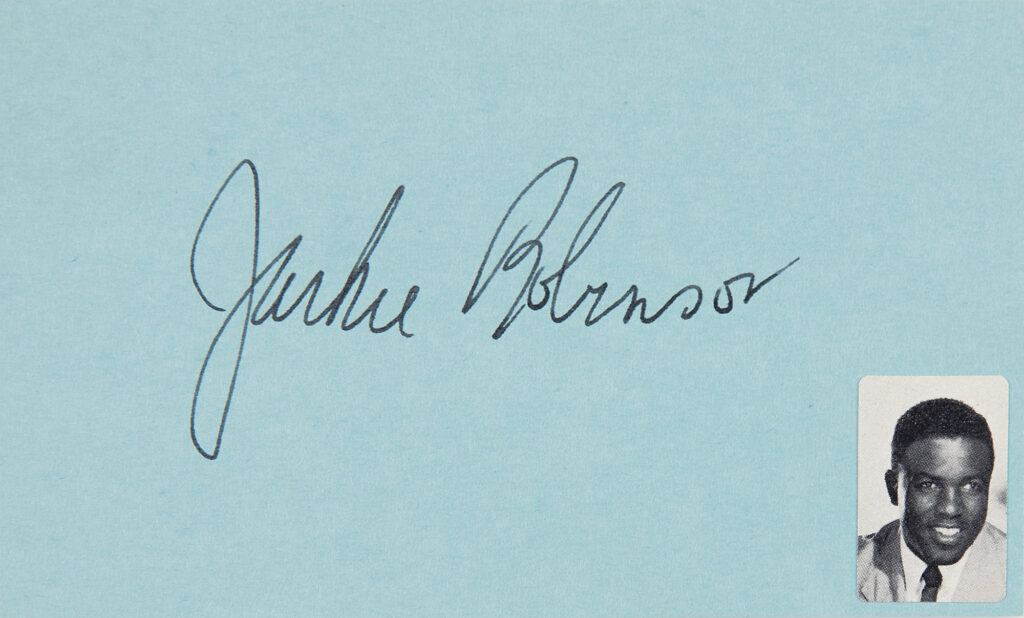Jackie Robinson signed index card, featuring a black-and-white photo of him in the lower right corner.