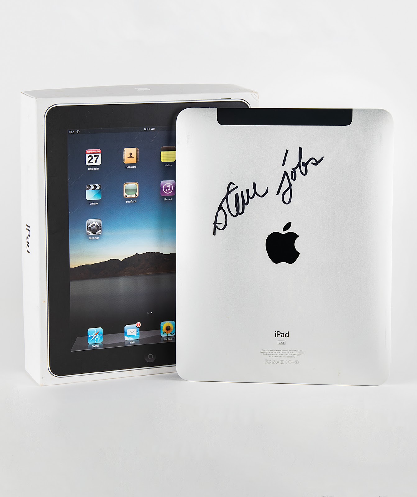 The iPad boldly signed by Steve Jobs pictured with its original packaging.