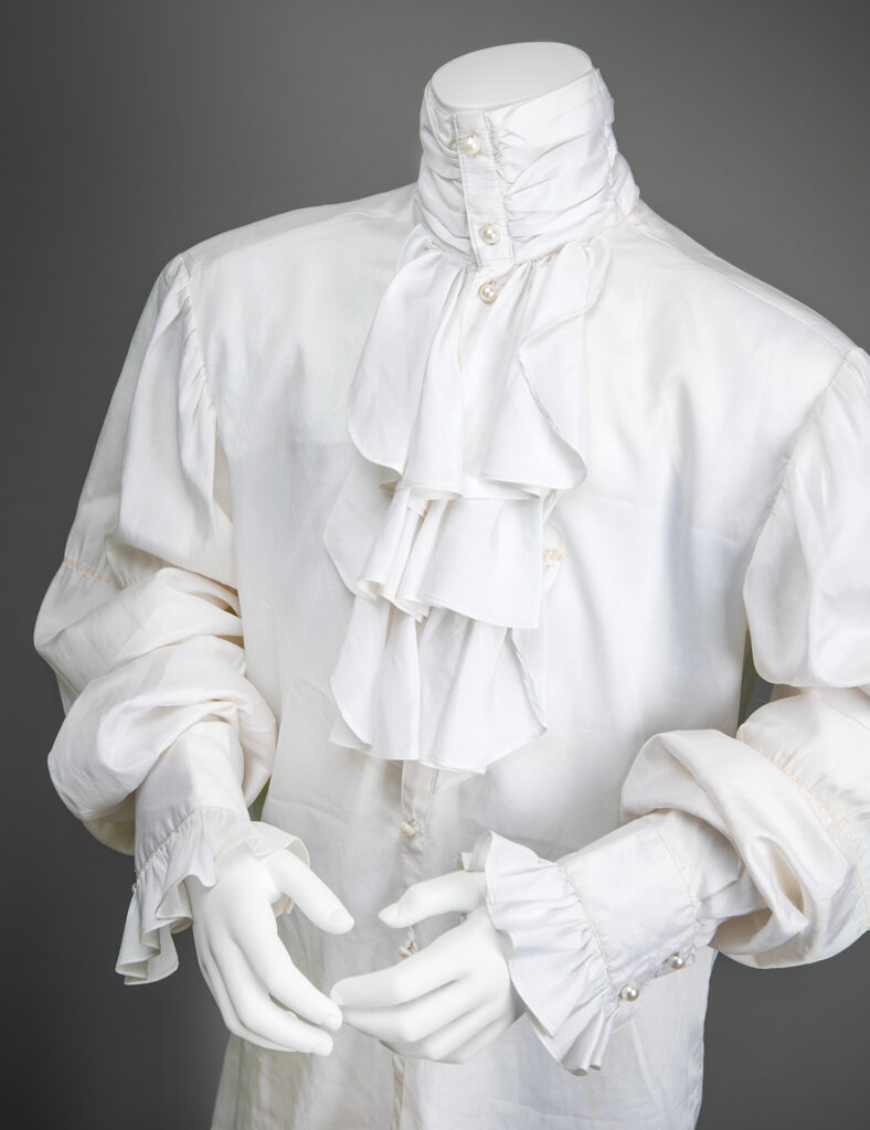 Prince’s ruffled shirt from the 1985 American Music Award performance of ‘Purple Rain.’ The shirt still was crafted from silk and embellished with faux pearl buttons.