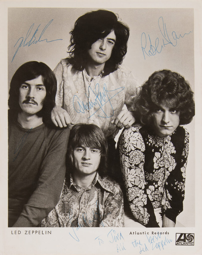 Original vintage photograph of Led Zeppelin released to promote their debut album, signed by band members Robert Plant, John Bonham, John Paul Jones, and Jimmy Page who adds an inscription: “To Jim, All the best, Led Zeppelin.”