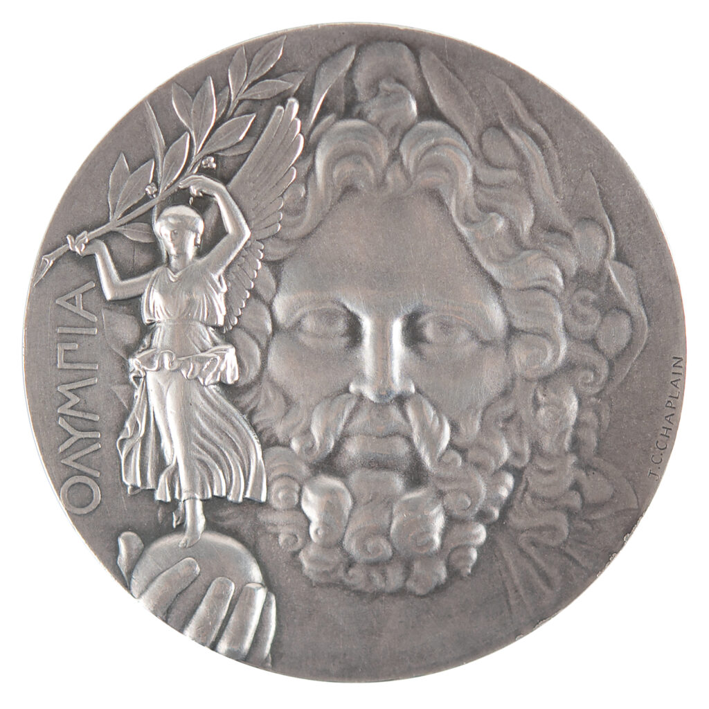 Original Athens 1896 ‘First Place’ silver winner’s medal, featuring the face of Zeus with Nike, the goddess of victory, in the palm of his hand.