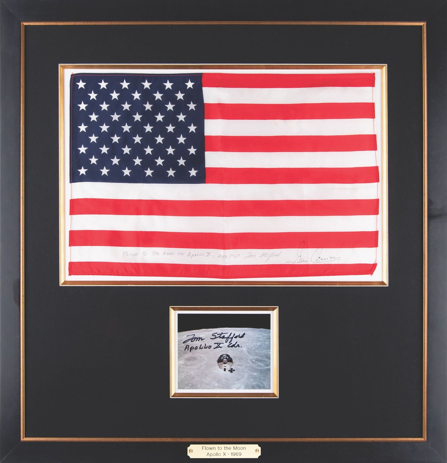 Tom Stafford’s flown American flag from the Apollo 10 mission, signed on one of the lower white stripes. The flag is framed along with a Stafford-signed photo.