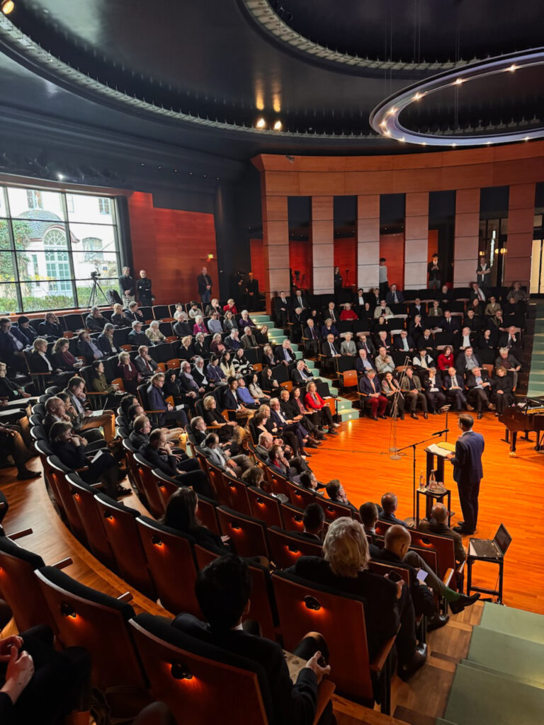 A grand image of the bidders seated inside the Beethoven-Haus Bonn.