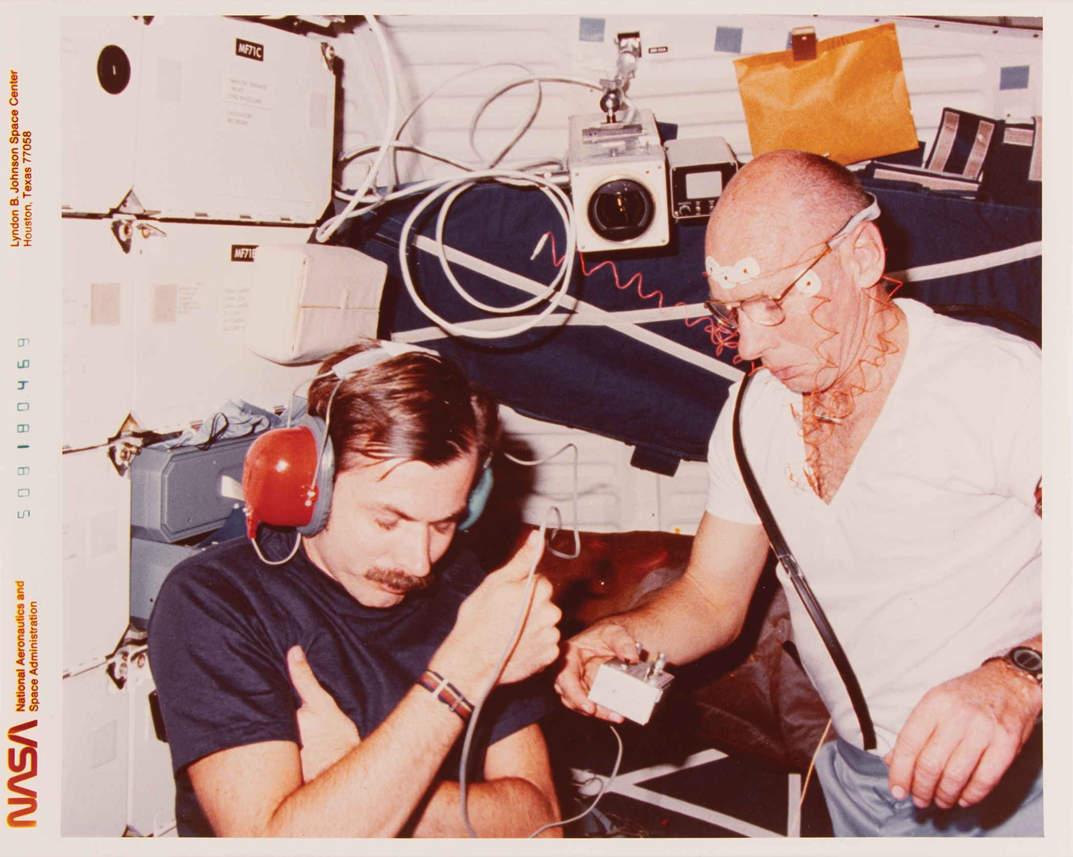 NASA astronaut William E. Thornton conducting a biomedical experiment aboard Challenger on STS-8