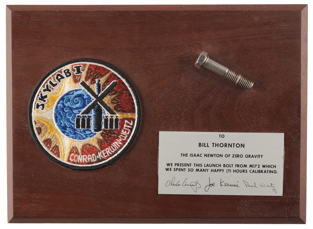 Skylab 2 flown bolt from the M172 body mass measurement device, presented to William Thornton as the Isaac Newton of Zero Gravity